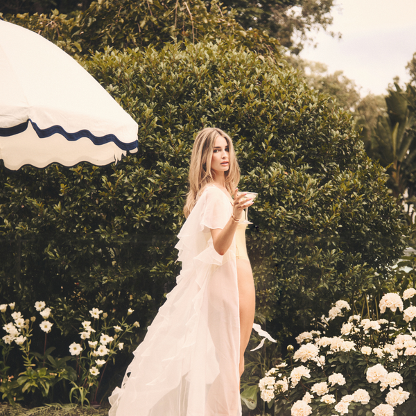 Bride in a long ruffled bridal robe, comparing robes and pyjama sets for wedding photos